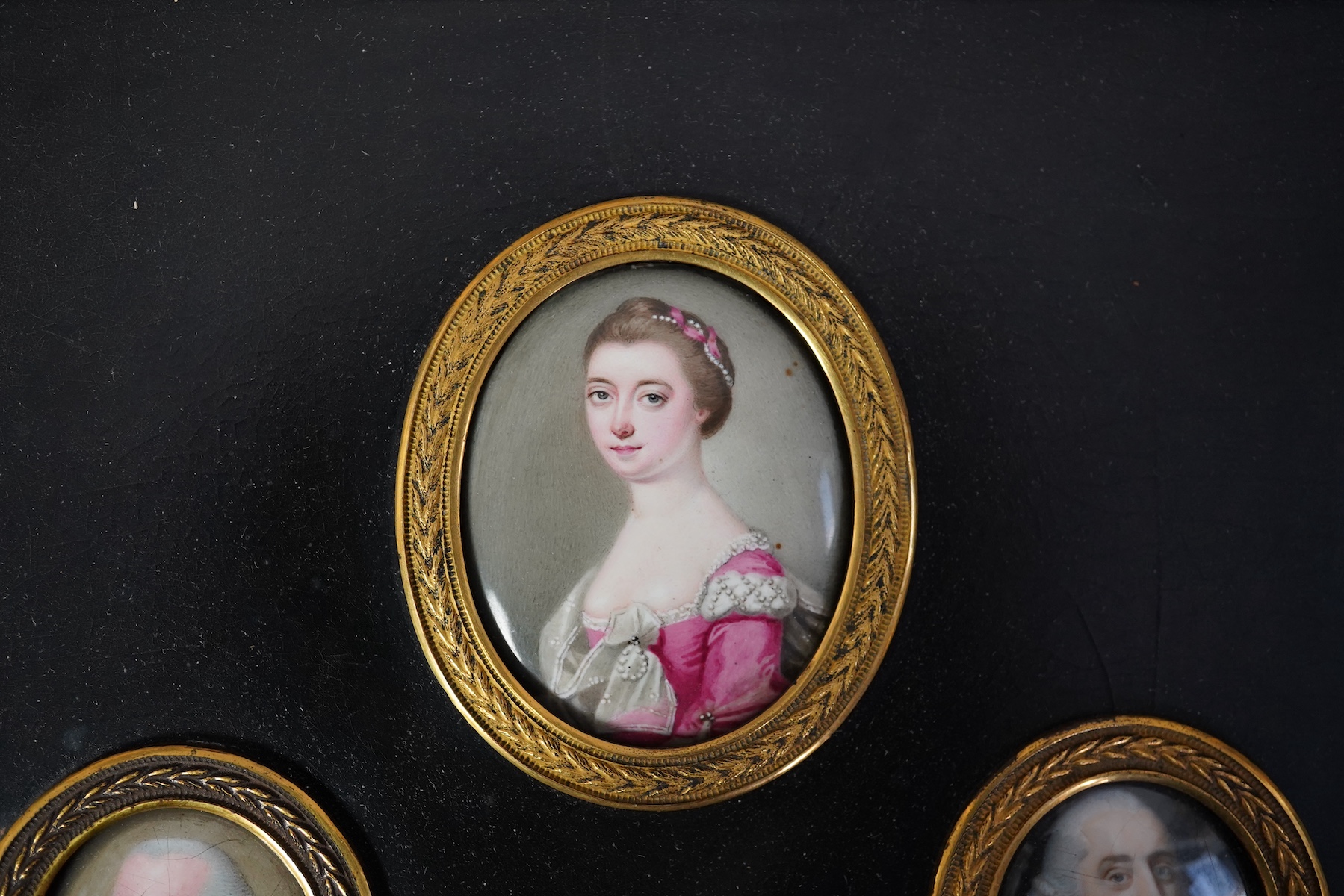 English School c.1760, Miniature portraits of the Cartwright Family, enamel on copper (4), largest 4.5 x 3.75cm, framed as one